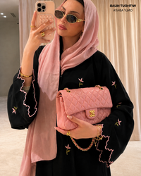 Black abaya with pink floral embroidery and cutwork, model front view