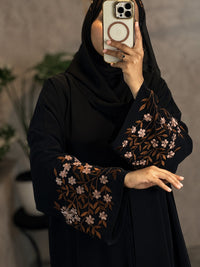 Black abaya front view with floral embroidered sleeves