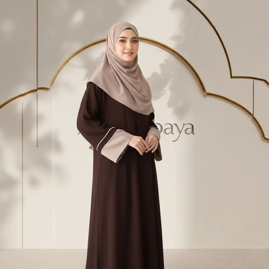 Woman wearing a brown dress with a beige hijab against a neutral background with 'baya' branding.