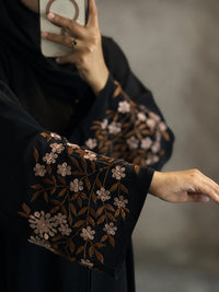 Close up floral embroidery on black abaya sleeve