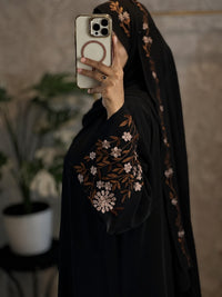 Side view of black floral embroidered abaya and hijab