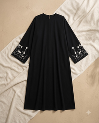 Black Firdous abaya showing white floral embroidery on the front - Aizel Abaya
