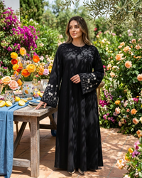 Black Firdous abaya full-length view with white floral embroidered sleeves - Aizel Abaya